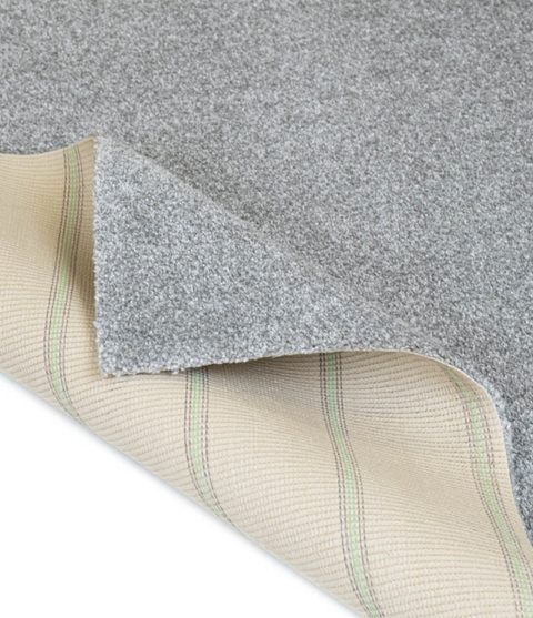 Silver carpet, corner turned back to show the backing
