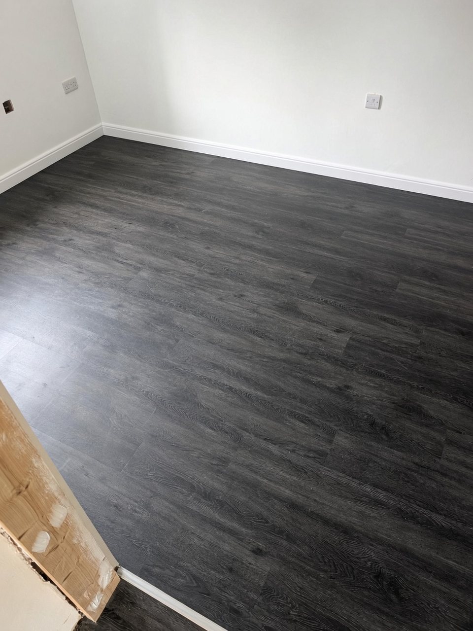 Finished room with dark grey oak-effect glue-down LVT