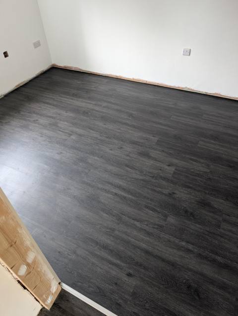 Finished living room with dark grey oak-effect LVT