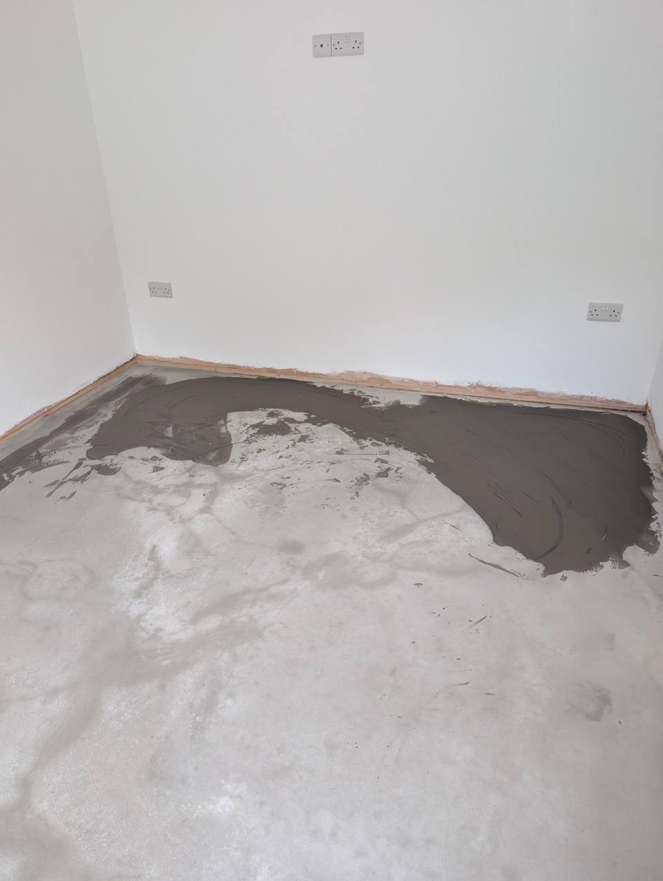 Subfloor being primed and screeded
