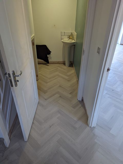 Light grey herringbone LVT, hall through to the WC