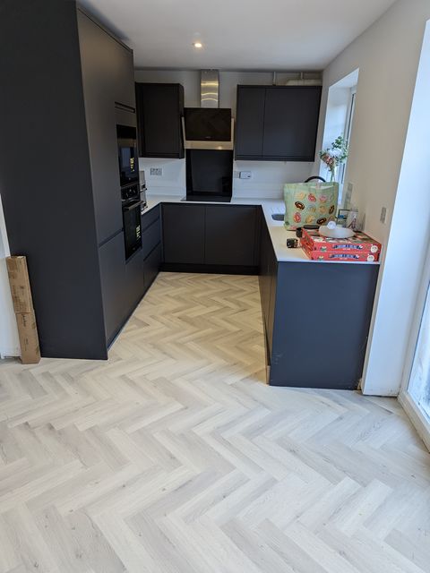 Light grey herringbone LVT through the whole ground floor: kitchen