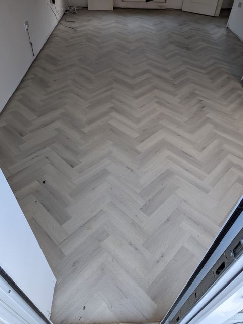 Light grey herringbone LVT through a doorway