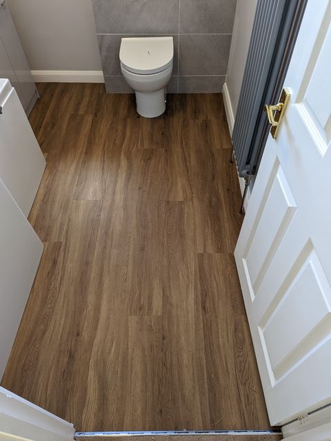Warm oak plank LVT in a bathroom, fitted on plyboard