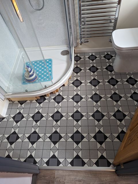 Victorian-style geometric vinyl, cut round a curved shower tray